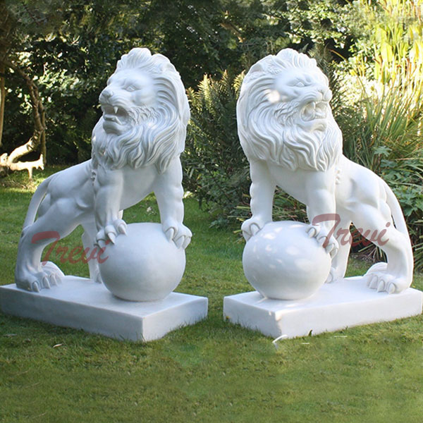 Pair of white marble decorative lion with paw on ball garden statues in front of house TMA-13